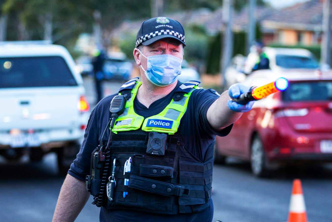 Police check drivers at a locked down Melbourne suburb. Photo: AAP/Daniel Pockett