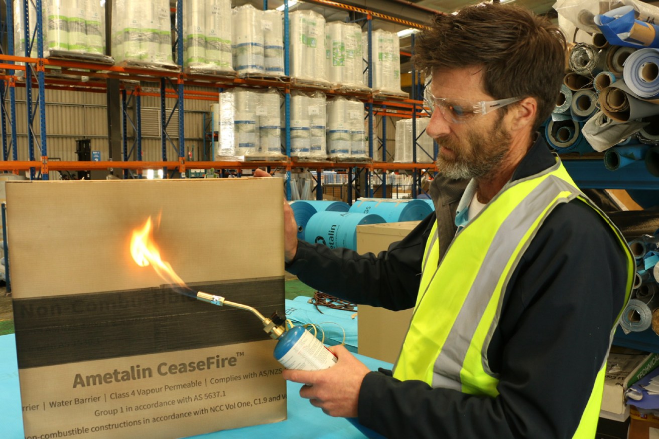 Ametalin technical director Craig Lumsden demonstrates the fire-proof capabilities of the company's latest product.