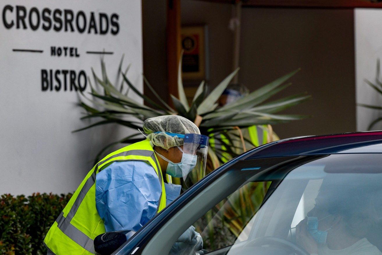NSW Health workers are administering COVID-19 tests to people in their cars at the Crossroads Hotel in Sydney. Photo: Bianca De Marchi/AAP
