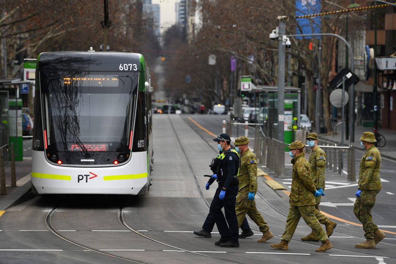 Victoria Police officers and ADF personnel patrol Melbourne CBD during state four lockdown restrictions and curfew. Photo: AAP/James Ross