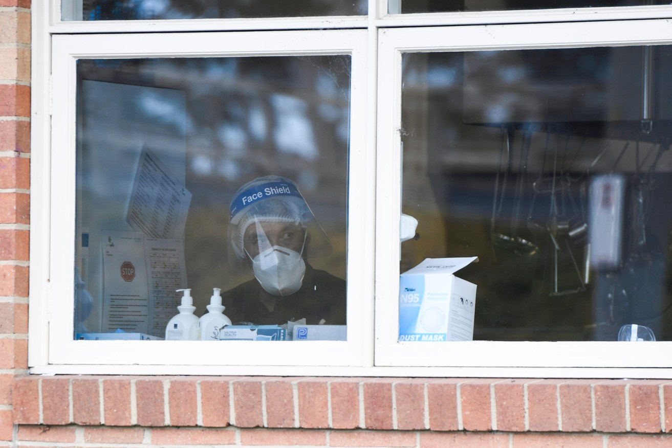A health worker inside a Melbourne aged care facility. Photo: AAP/Erik Anderson