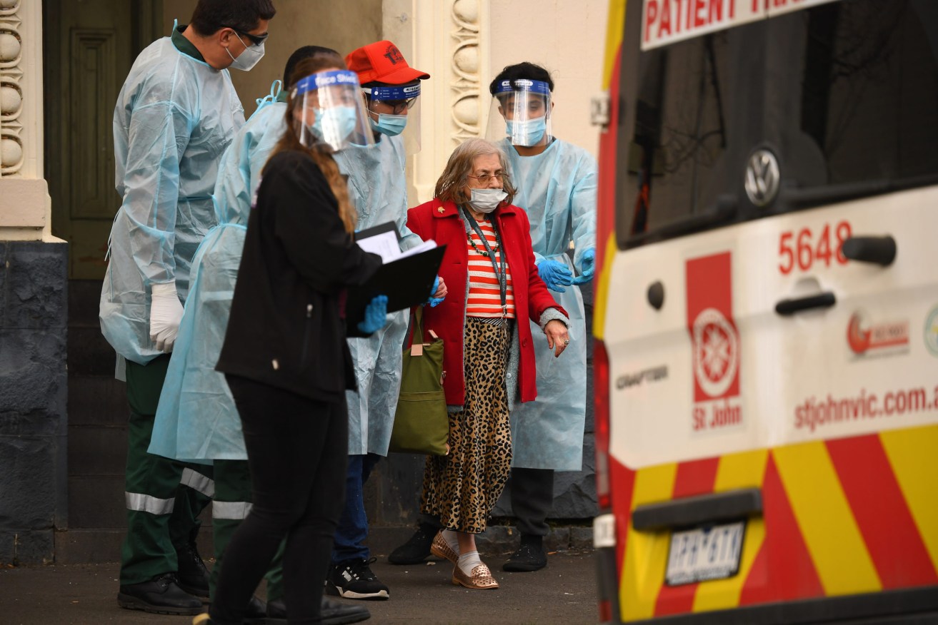 Residents of Melbourne's Hambleton House are removed after a breach of coronavirus restrictions. Photo: AAP/James Ross