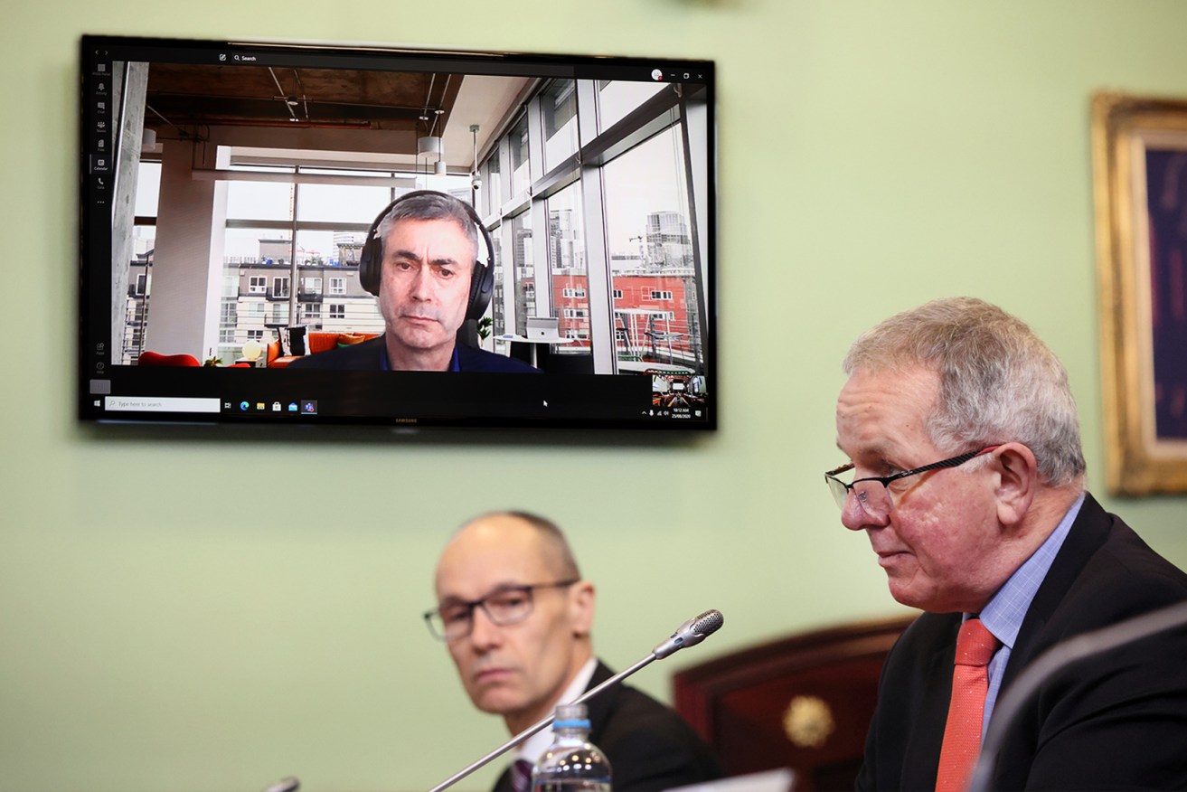 Tony Braxton-Smith addresses the committee today, while Fergus Gammie is seen on a screen from Sydney. Photo: Tony Lewis / InDaily