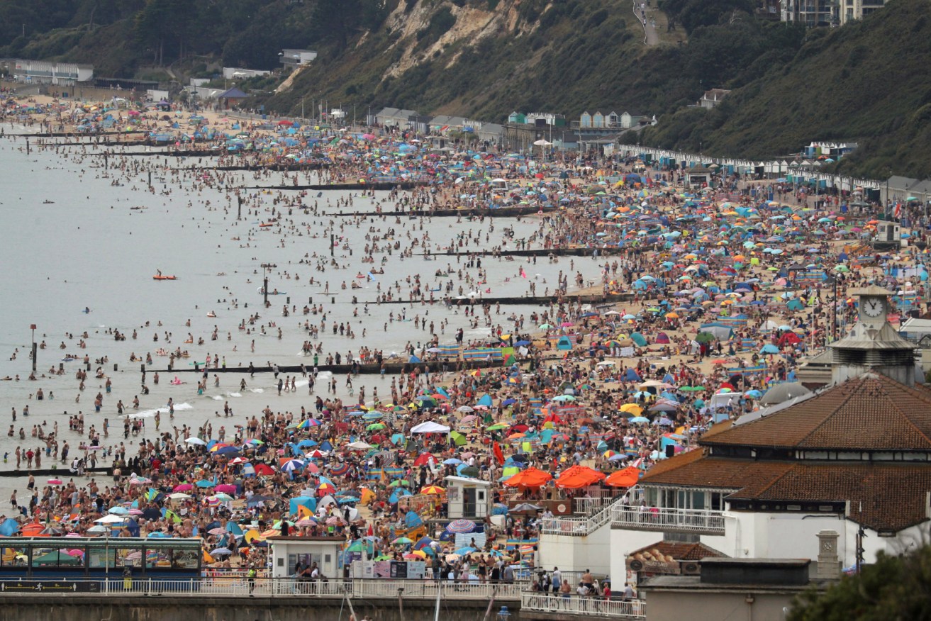 Crowds at Bournemouth in August. Photo: Andrew Matthews/PA via AP