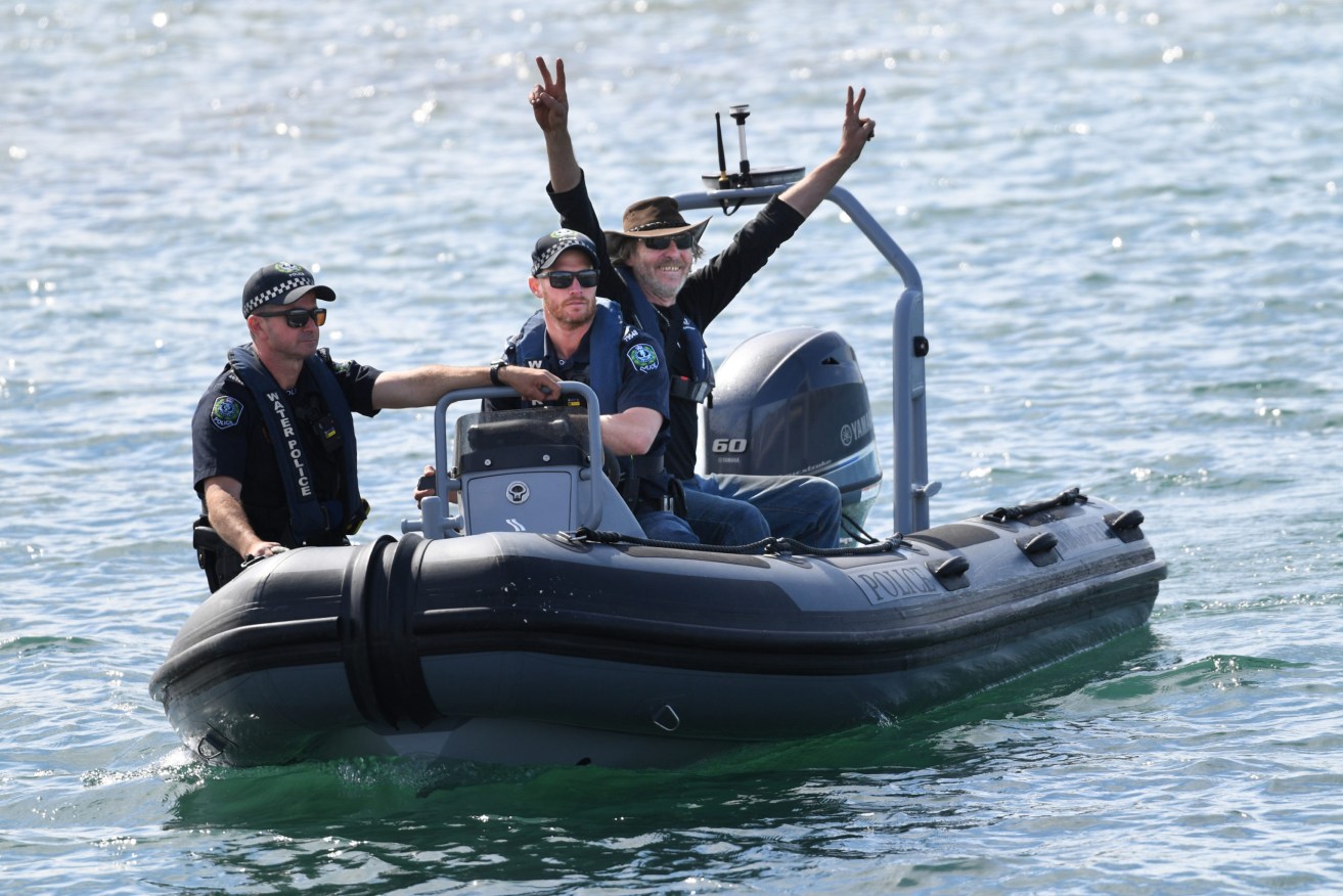 Fisherman Derek Robinson reacts after seeing his family on his to return at Encounter Bay. Photo: David Mariuz / AAP