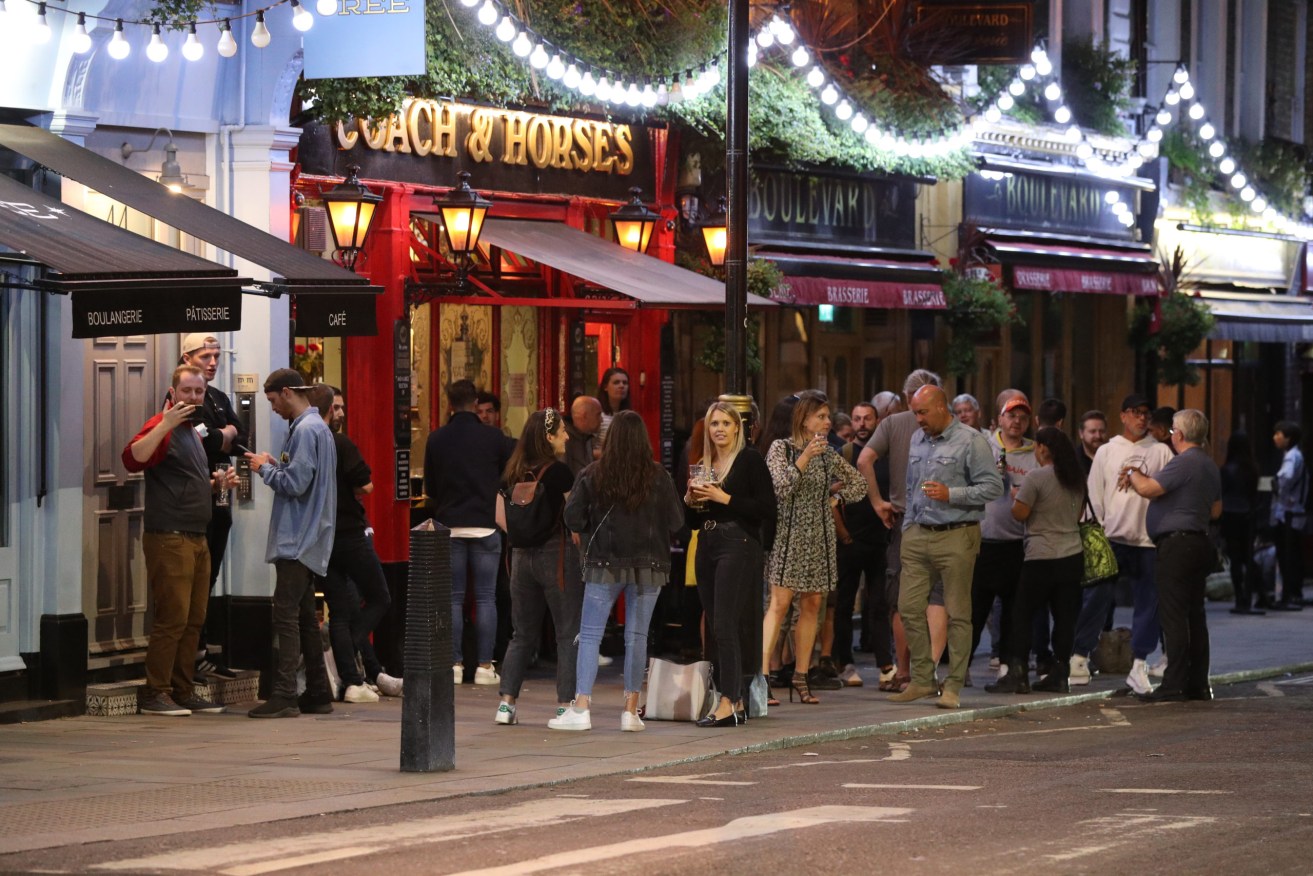 Drinkers outside a London pub on the weekend, before new gathering laws took effect. Photo: Jonathan Brady/PA Wire