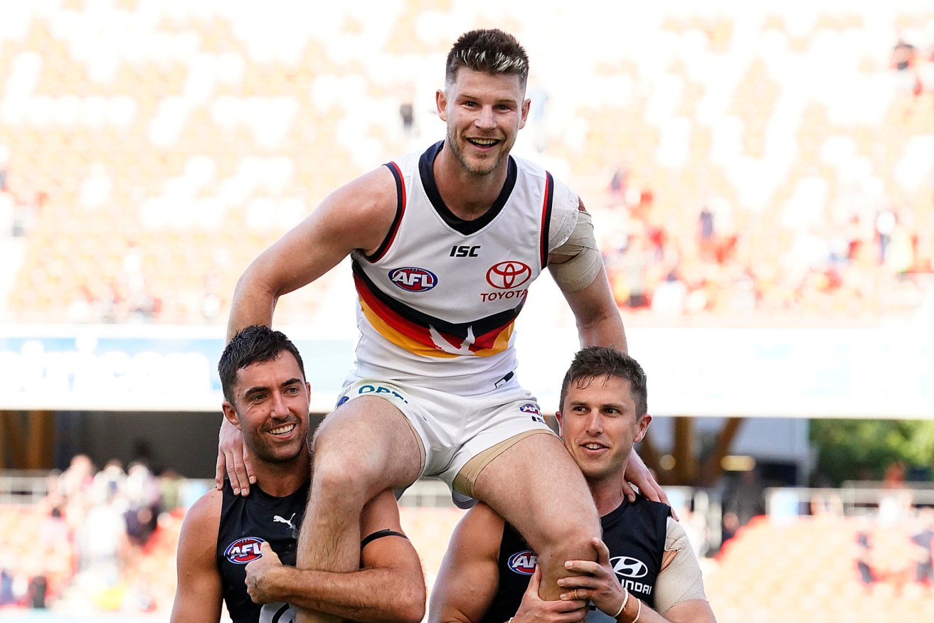 A triumphant Bryce Gibbs is chaired off the ground by two of his team... er, ex-teammates yesterday. Photo: Dave Hunt / AAP