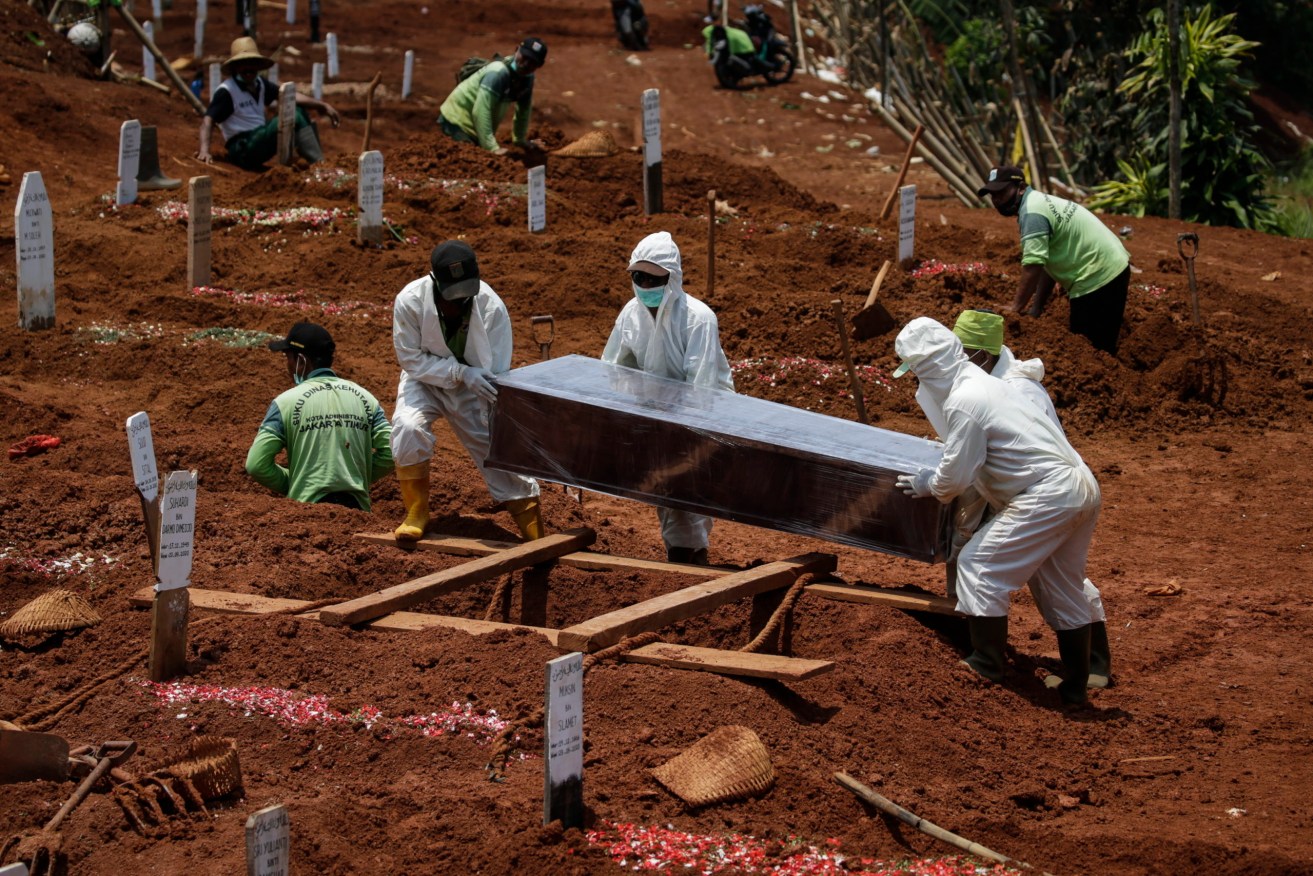 A COVID-19 victim is buried in Jakarta, Indonesia last week. Photo: EPA/MAST IRHAM