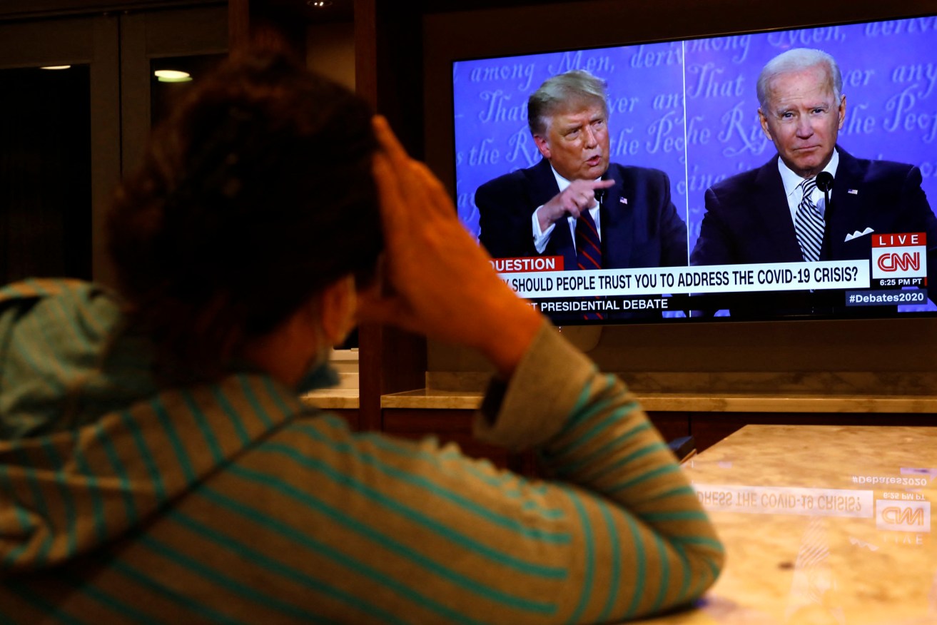 A woman in Washington watches the first presidential campaign debate between President Donald Trump and Democratic presidential nominee Joe Biden. Photo: Yuri Gripas/ABACAPRESS.COM