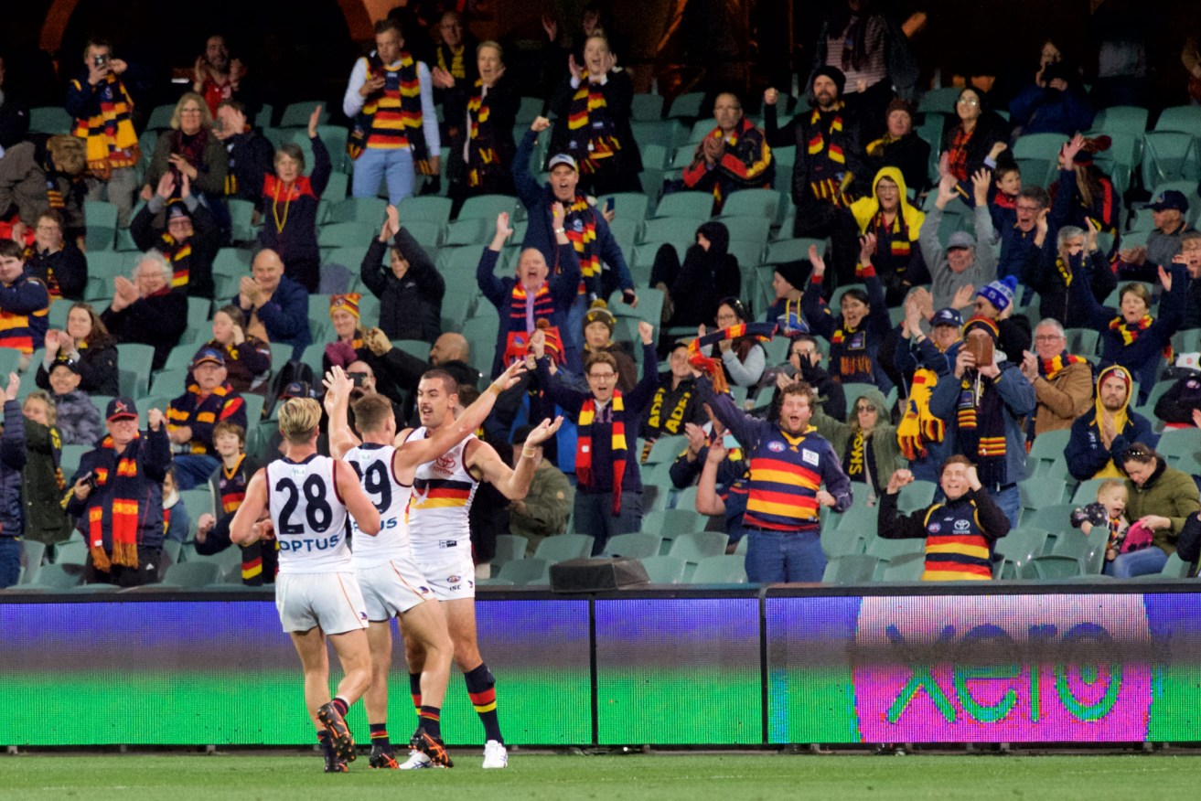 At last, the players and spectators have something to celebrate, as the signage on the boundary no longer points to our winning tally in 2020. Photo: Michael Errey / InDaily