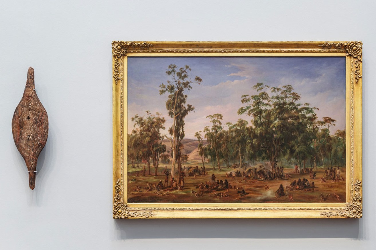 The rare Murlapaka (shield) is displayed alongside Alexander Schramm's painting 'An Aboriginal encampment, near the Adelaide foothills'. Photo: Saul Steed