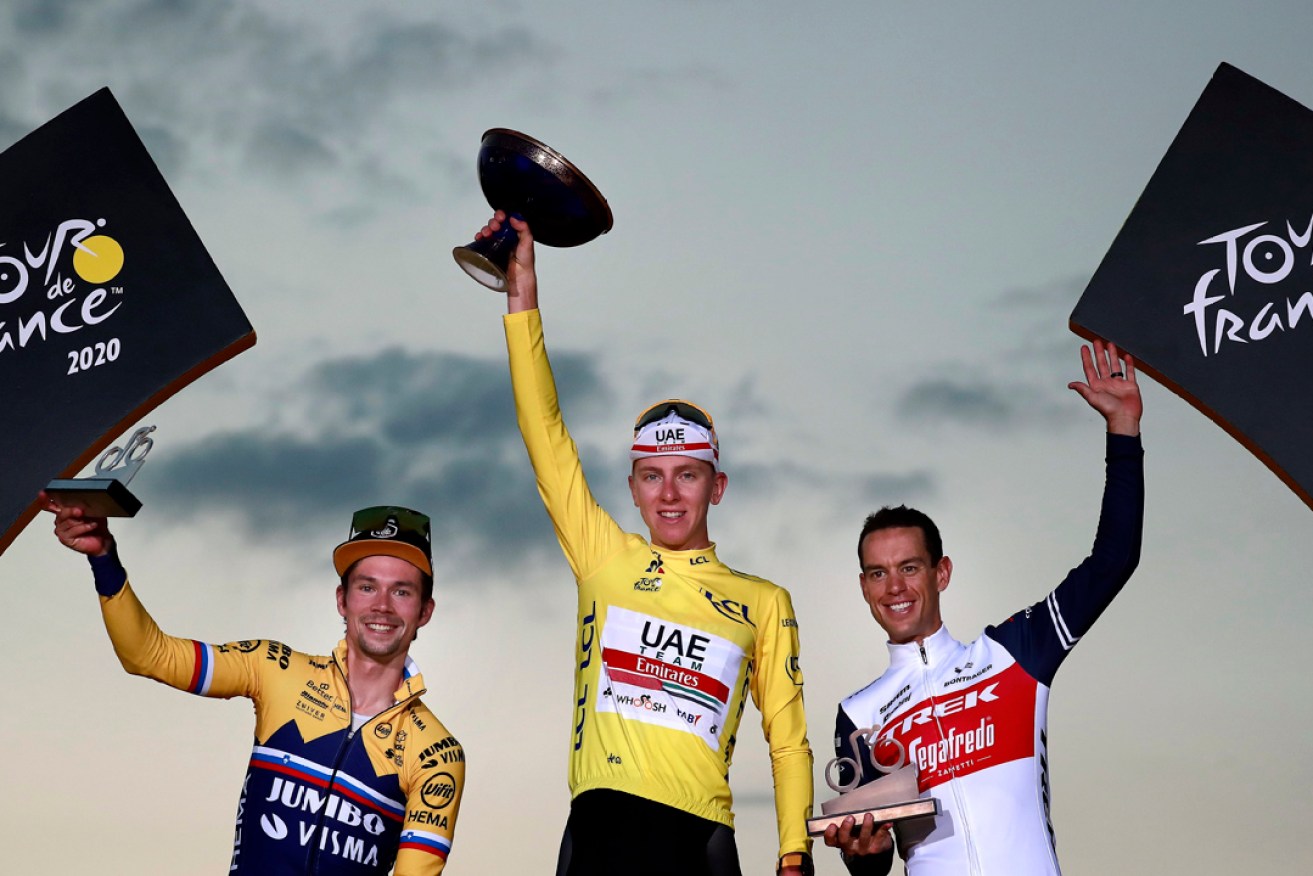Richie Porte, right, has become only the second Aussie cyclist to finish on the Tour de France podium after securing third place in the event behind Slovenian riders  Tadej Pogacar and Primoz Roglic. Picture: Christophe Petit-Tesson/EPA