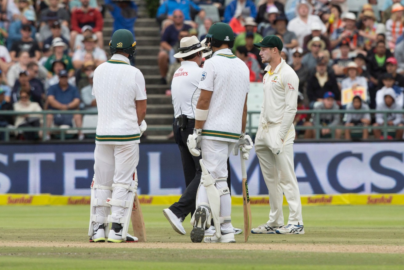 Umpires question Australia's Cameron Bancroft about ball tampering during the third Test against South Africa at Cape Town in March 2018. Photo: AP/Halden Krog