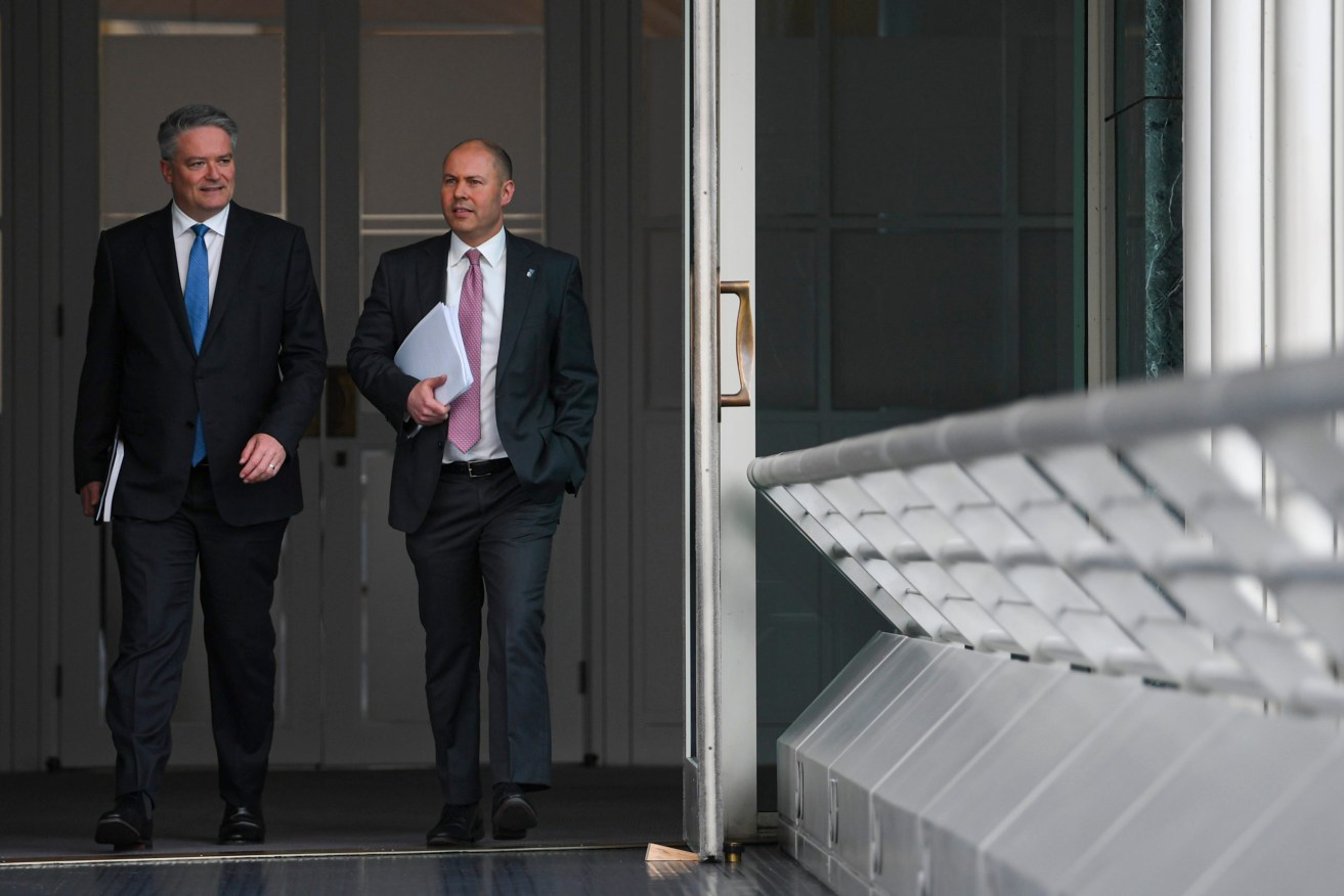 Finance Minister Mathias Cormann (left) and Australian Treasurer Josh Frydenberg arrive to speak to journalists inside the Budget lockup today. Photo: AAP/Lukas Coch