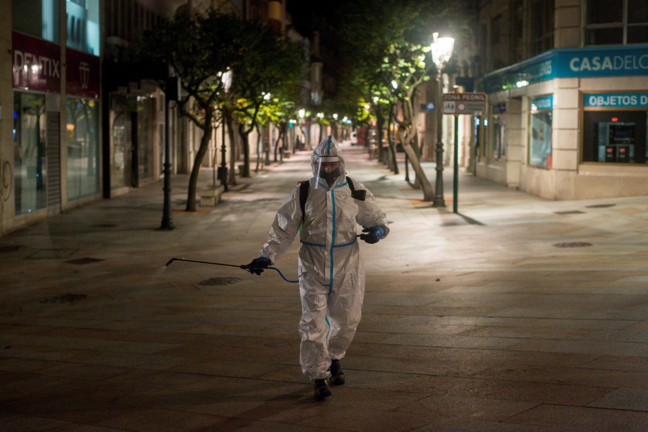 Disinfectant is spread during curfew near Barcelona this week. Photo: EPA/Brais Lorenzo