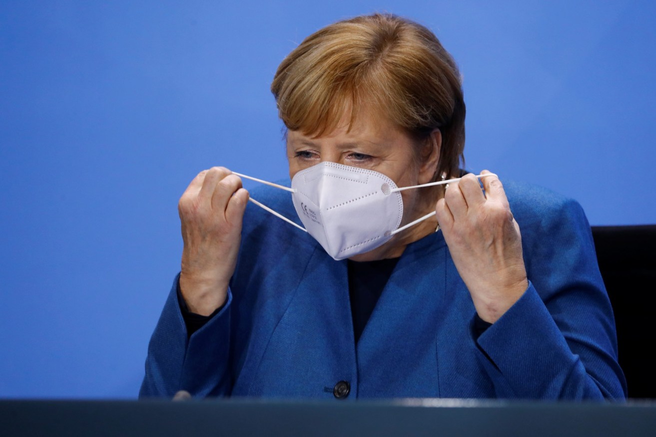 German Chancellor Angela Merkel says new virus cases risk swamping the health system. Photo: Fabrizio Bensch/Reuters Pool/dpa
