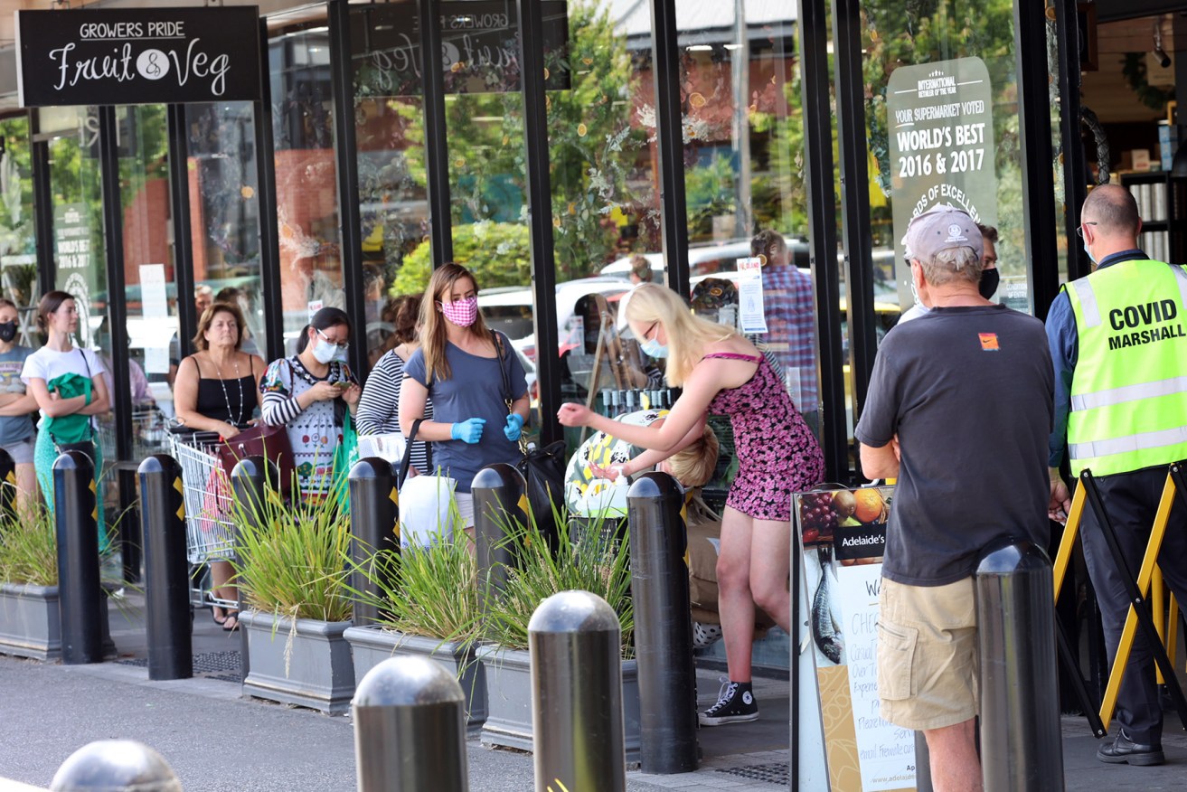 Shoppers queue outside Frewville Foodland as panic buying was reported across Adelaide ahead of the six-day lockdown. Picture: Tony Lewis/InDaily