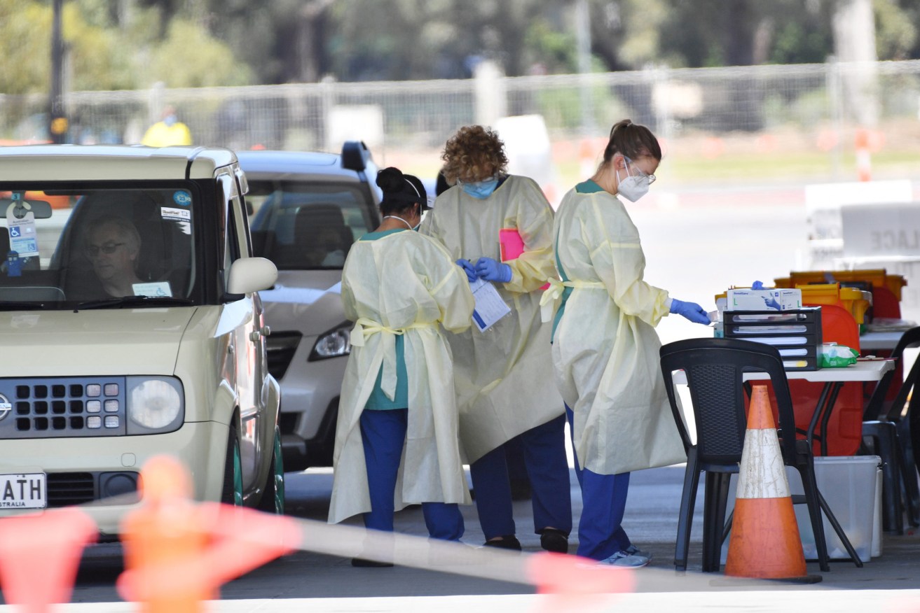 Health workers at the Victoria Park drive-through testing site yesterday. Photo: David Mariuz/AAP