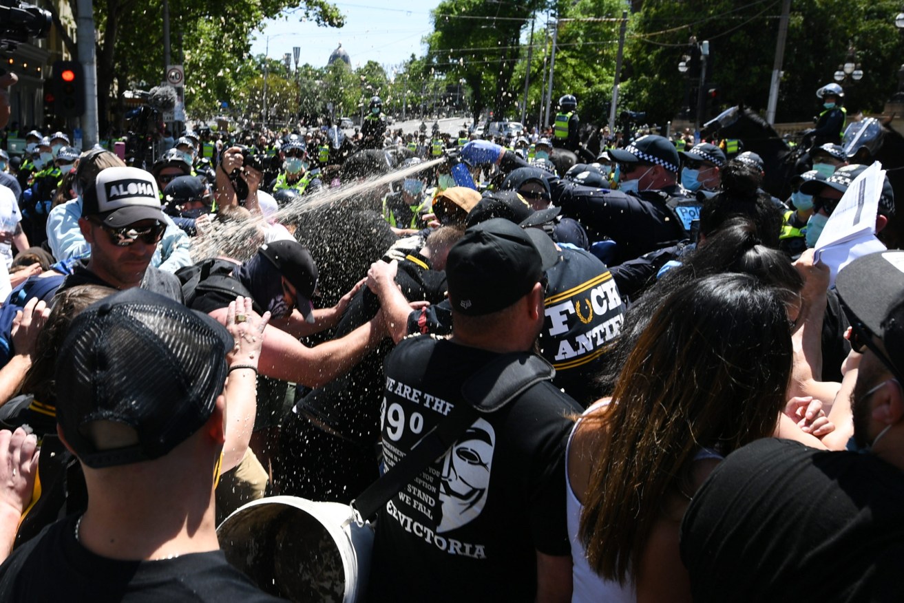 Police spray protesters during an anti-lockdown rally in Melbourne on November 3. Photo: AAP/Erik Anderson