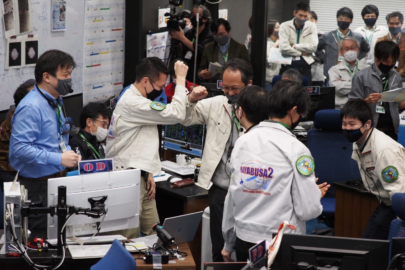 Japan Aerospace Exploration Agency staff celebrate after a capsule successfully separated from the space probe Hayabusa2 before landing near Woomera. Image: EPA/JAXA 