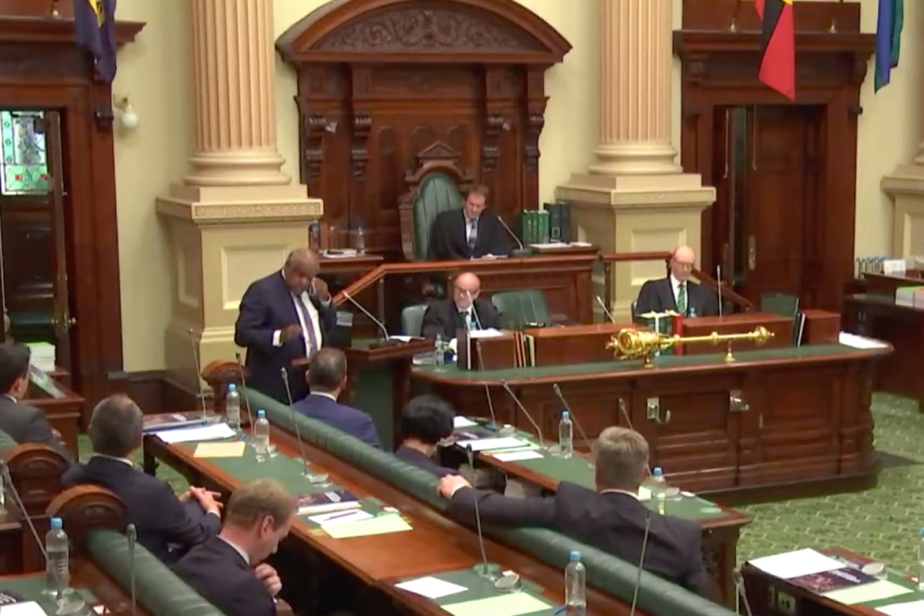 Aboriginal Engagement Commissioner Dr Roger Thomas wiping away tears as he delivers a historic address to parliament. Photo: Screenshot of SA Parliament broadcast