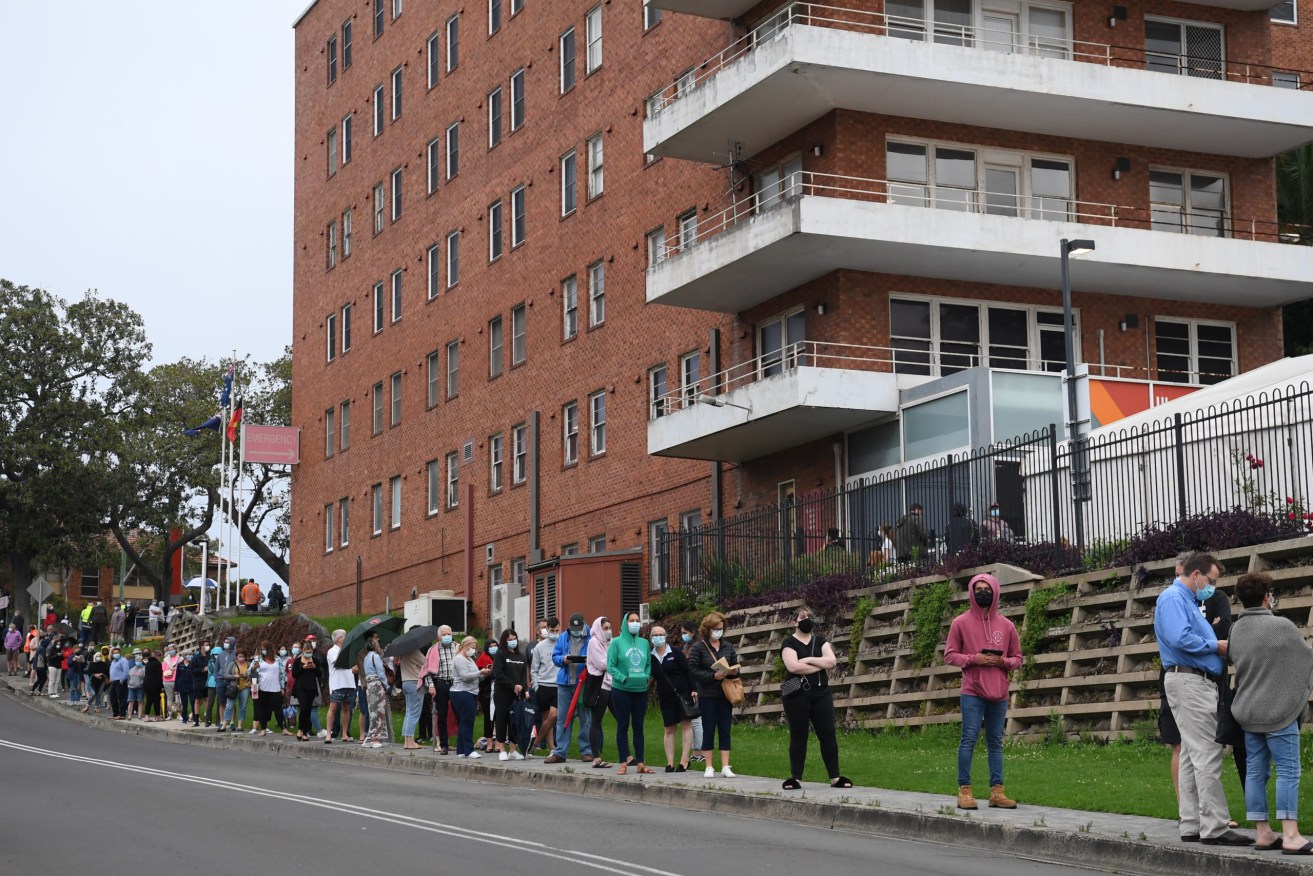 Long lines of people waiting to be tested for COVID-19 snake around the block at Wollongong Hospital in NSW. Picture: Dean Lewins/AAP
