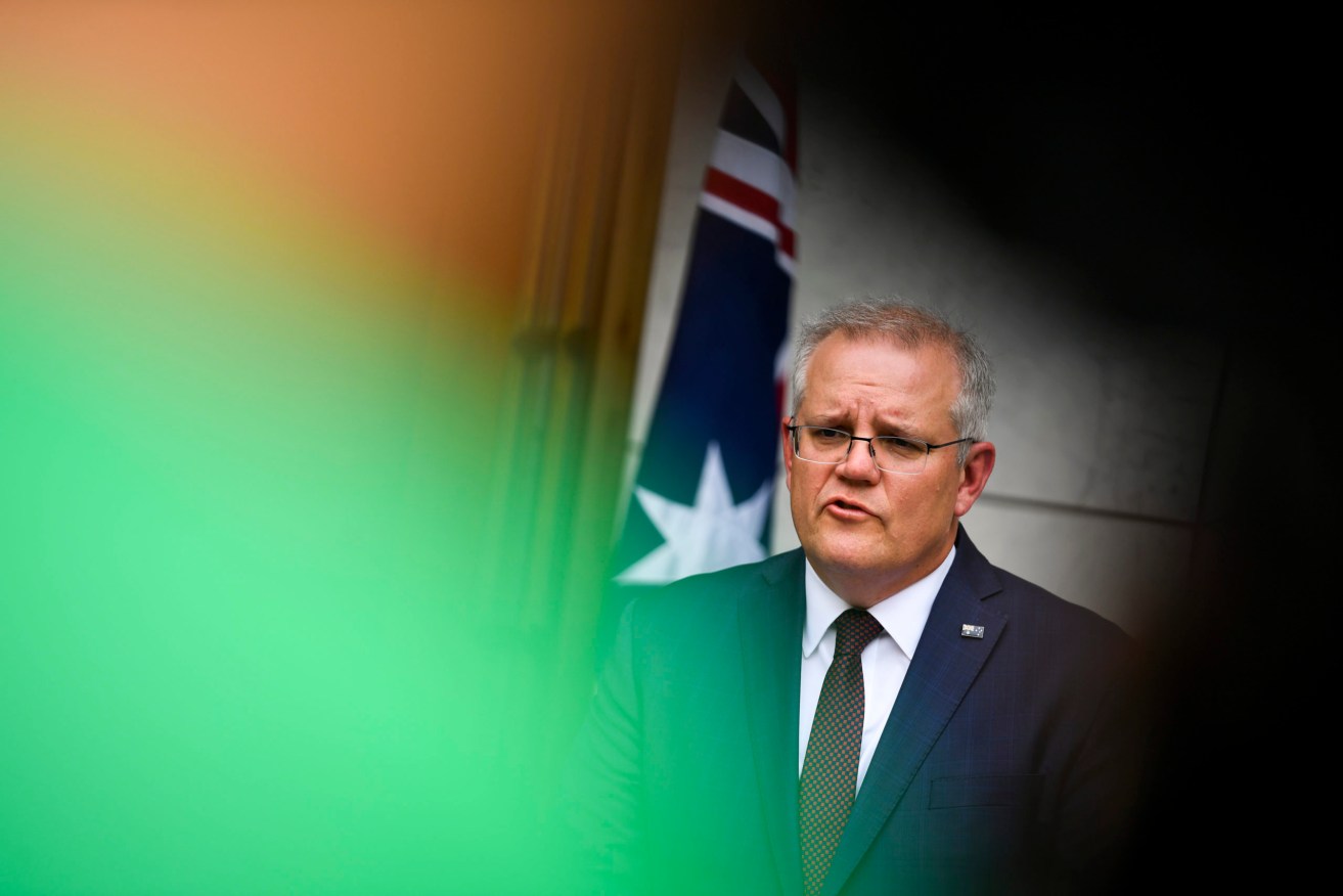 Scott Morrison says the vaccine should now be available to some Australians from February. Photo: Lukas Coch / AAP