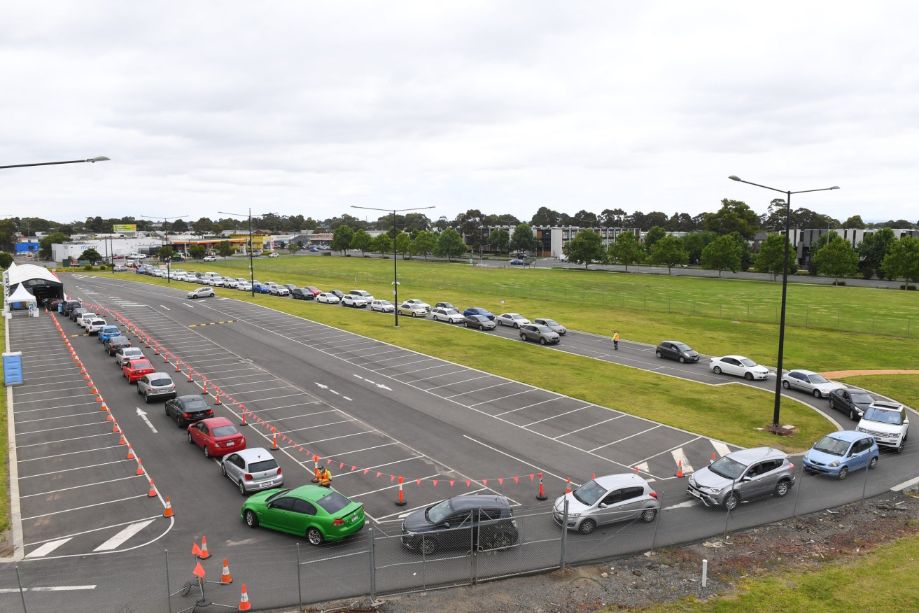 A long line of cars queue at a testing site in Melbourne. Photo: AAP/James Ross