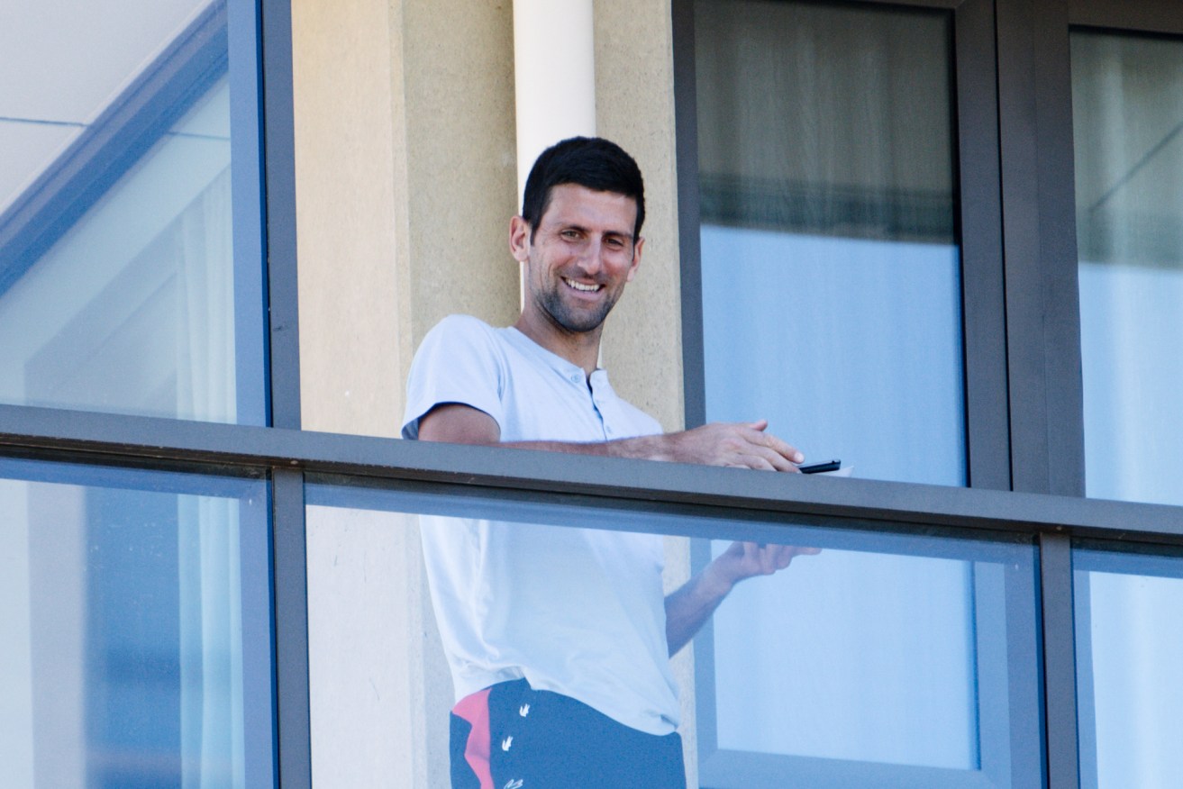 Novak Djokovic on the balcony at The M Suites in North Adelaide this week. Photo: Morgan Sette / AAP