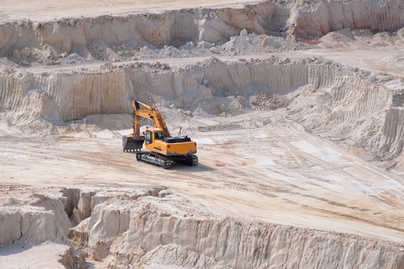 Heavy industrial equipment in open mine kaolinite quarry