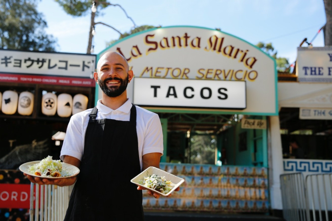 Felipe Arias with gluten-free Mexican food from Santa Maria Taqueria in the Garden of Unearthly Delights. Photo: Ben Kelly.