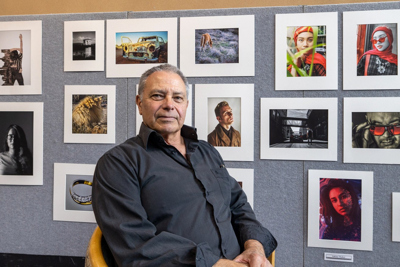 Photography teacher Malcolm Cheffirs with an exhibition of his students' work
Photo: Tony Lewis / InDaily