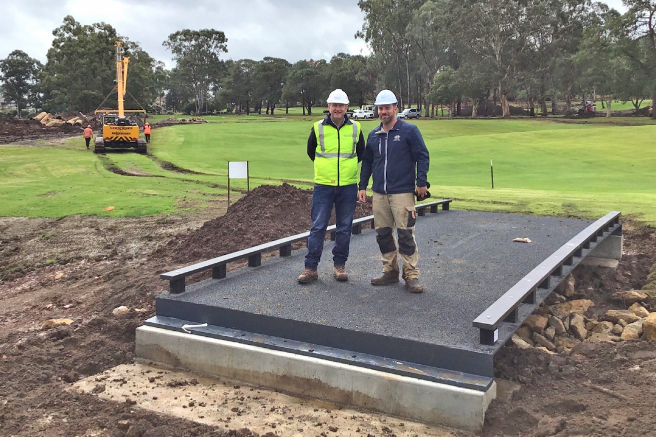 SIS structures director Nick Wotton and Castle Hill Country Club superintendent Mitch Brooks on one of the newly installed FRP bridges in July 2019.