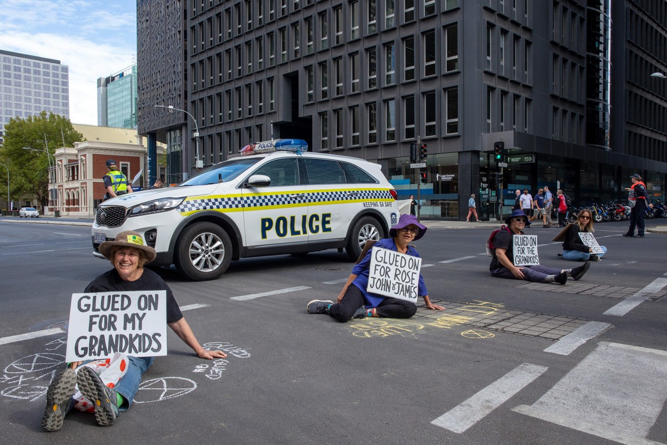 Extinction Rebellion protestors glued to Flinders Street this morning (Photo: Tony Lewis/InDaily)
