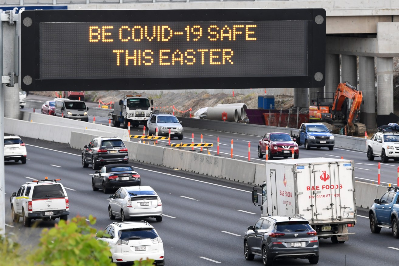A traffic sign displaying a COVID-19 on the Pacific Motorway in Brisbane. Image: AAP Image/Darren England.