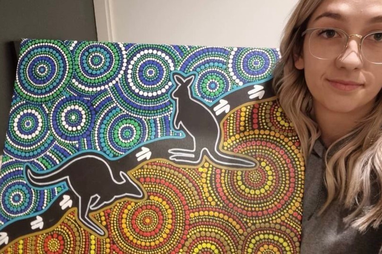 Artist Elle Campbell with the painting she claims has been plagiarised. Photo: Instagram 