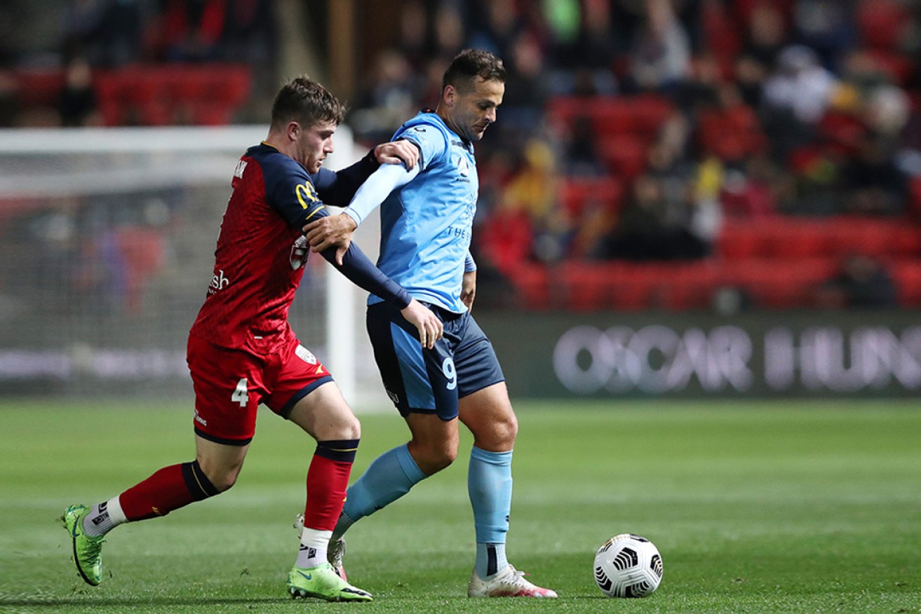 United's Ryan Strain and Sydney FC's Deyvison Da Silva during the clubs' last clash in May. Photo: AAP/Sarah Reed