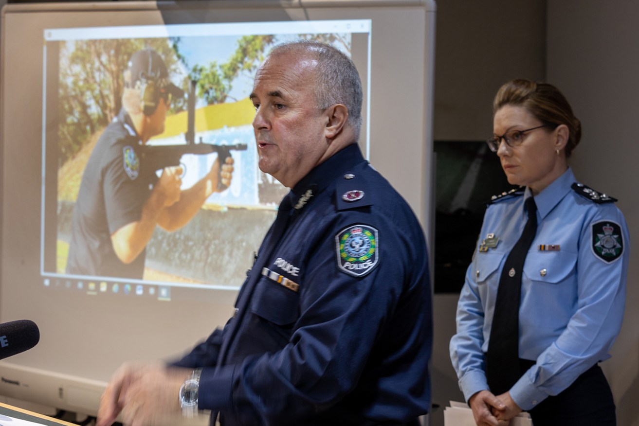 SA Police assistant commander Peter Harvey and AFL commander Erica Mirren with images of an automatic weapon seized during raids. (Photo: Tony Lewis/InDaily)