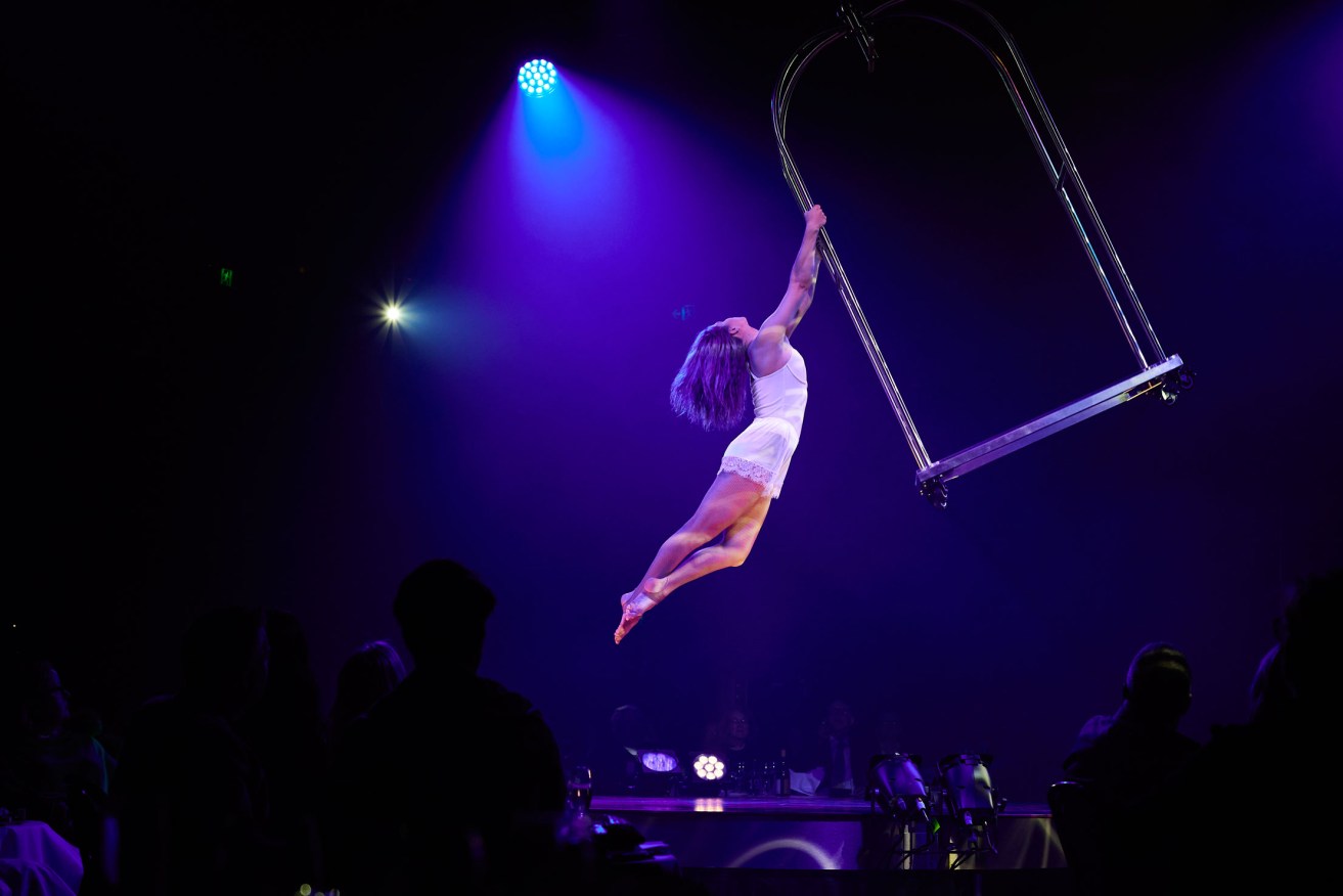 Circus artist Masha Terentieva wows the L'Hotel audience with her performance on a concierge’s cart suspended above them. Photo: Claudio Rashcella