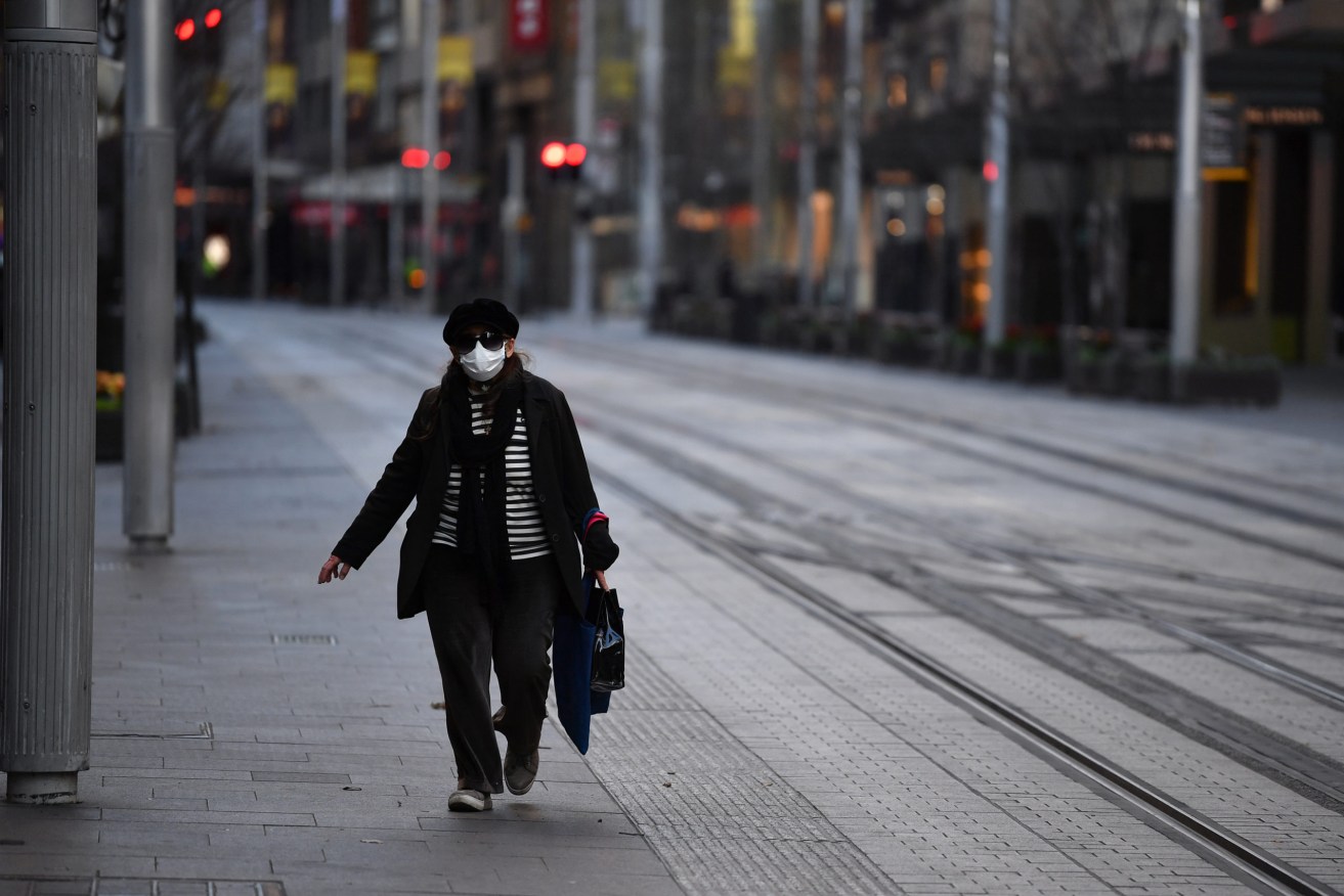 A pedestrian wearing a face mask in the central business district in Sydney, Thursday, July 22, 2021 (AAP Image/Joel Carrett)