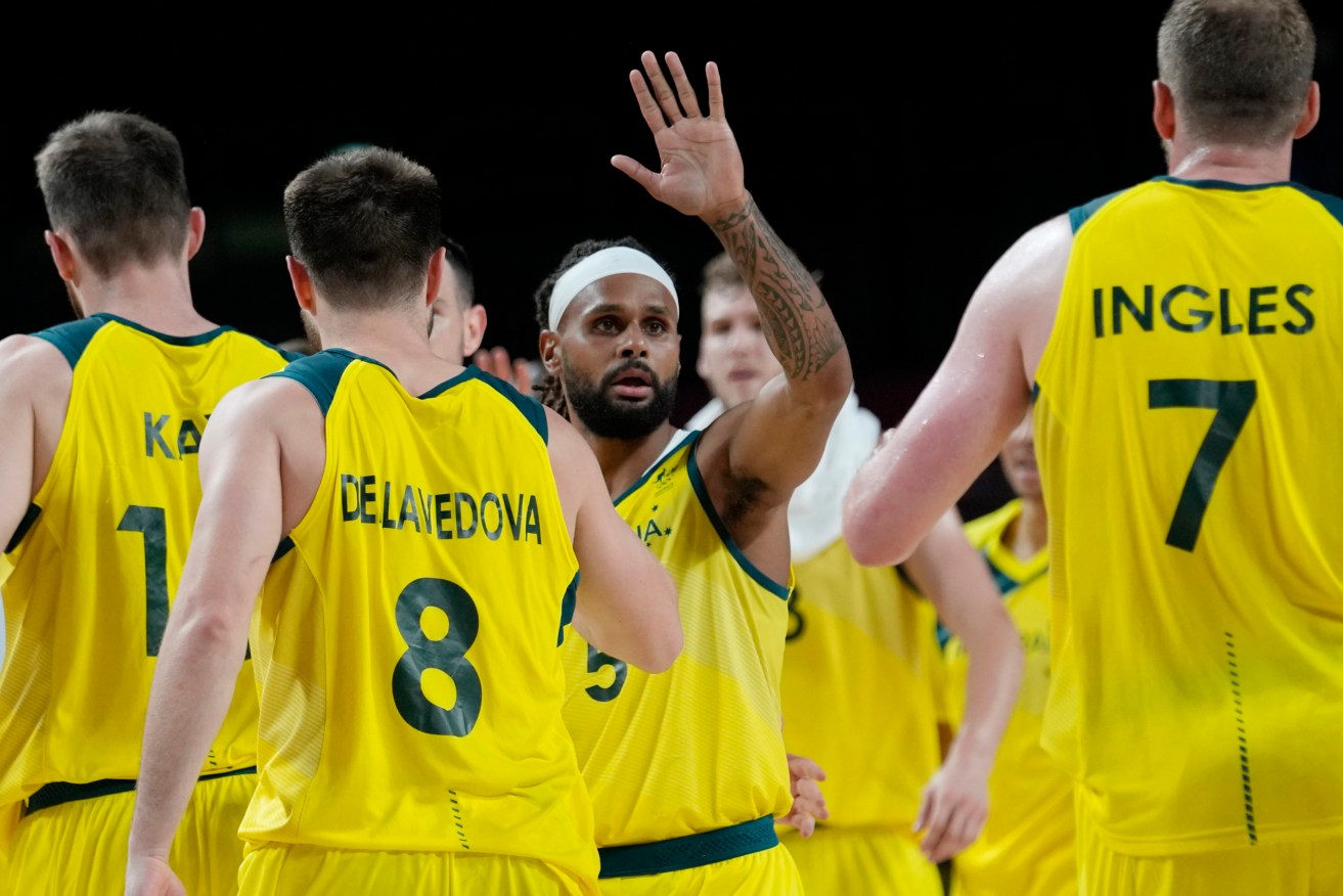 Australia's Patty Mills (5) celebrates with teammates during the men's basketball quarterfinal round game against Argentina at the 2020 Summer Olympics, Tuesday, Aug. 3, 2021 (AP Photo/Eric Gay)
