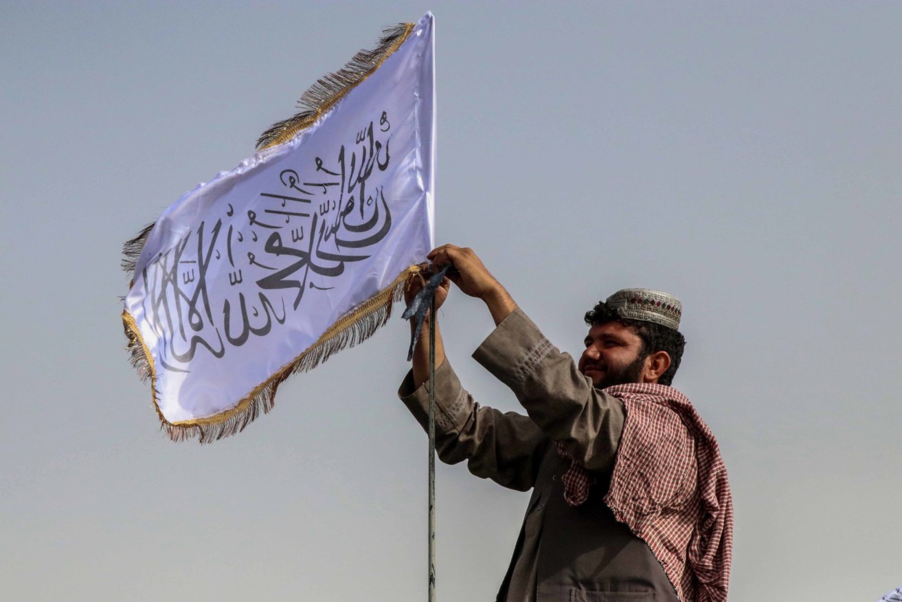 A Taliban fighter and flag. Photo supplied
