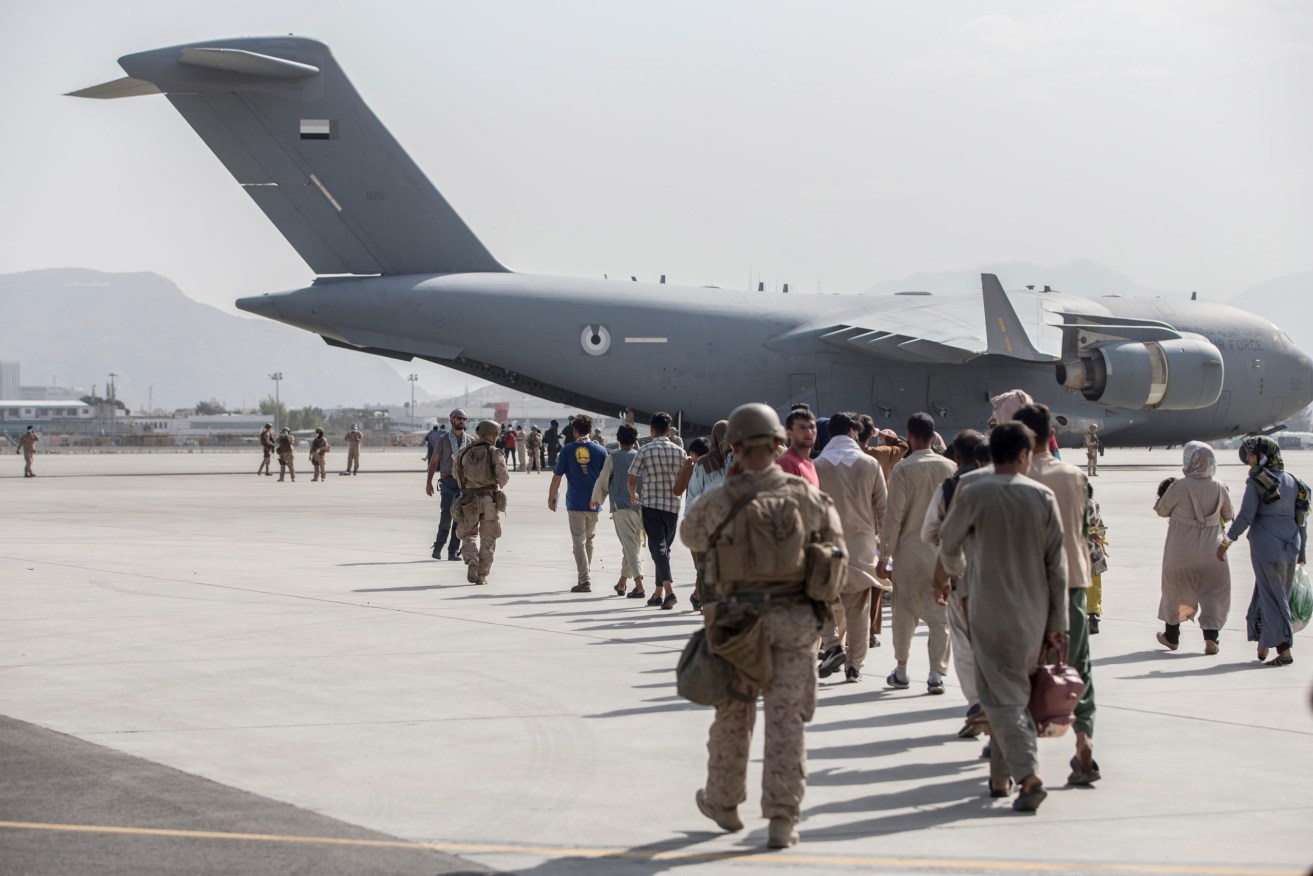 
Evacuees board a US Air Force plane at Kabul airport. Photo: Sgt. Samuel Ruiz/U.S. Marine Corps via AP