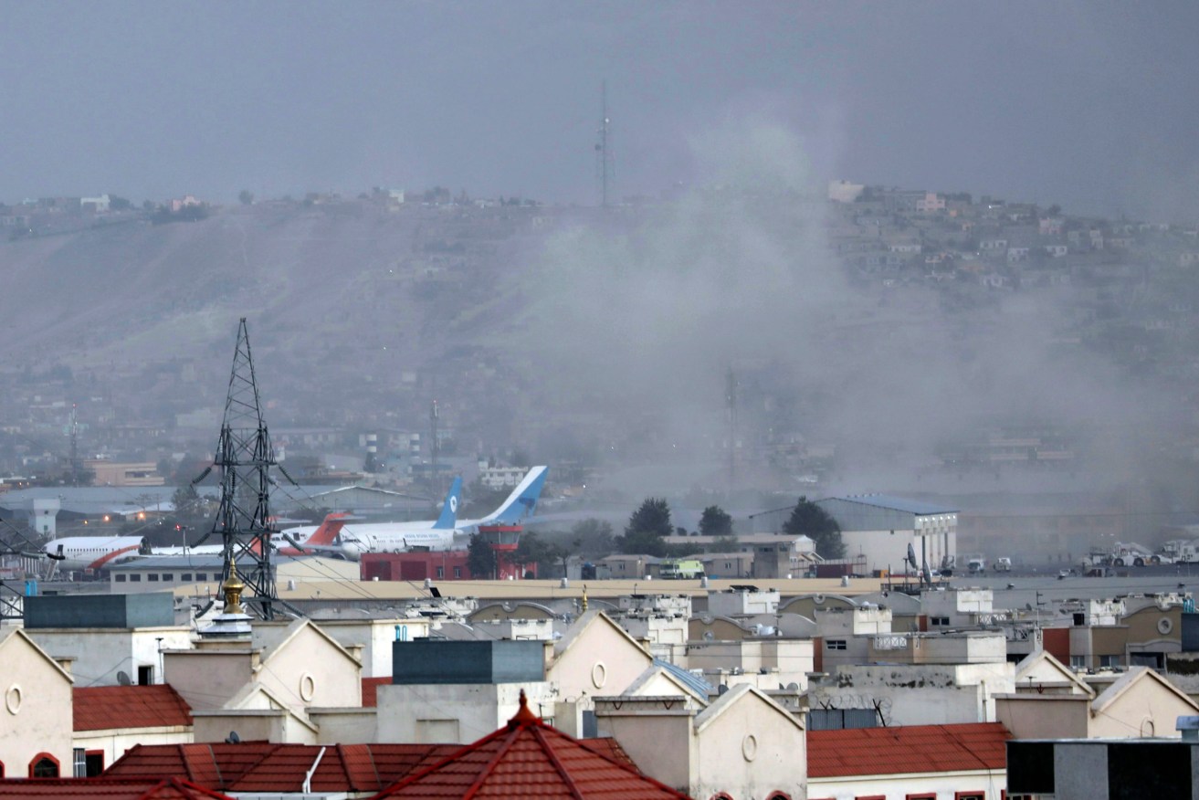 Smoke rises from the airport after two bombings. Photo: AP /Wali Sabawoon