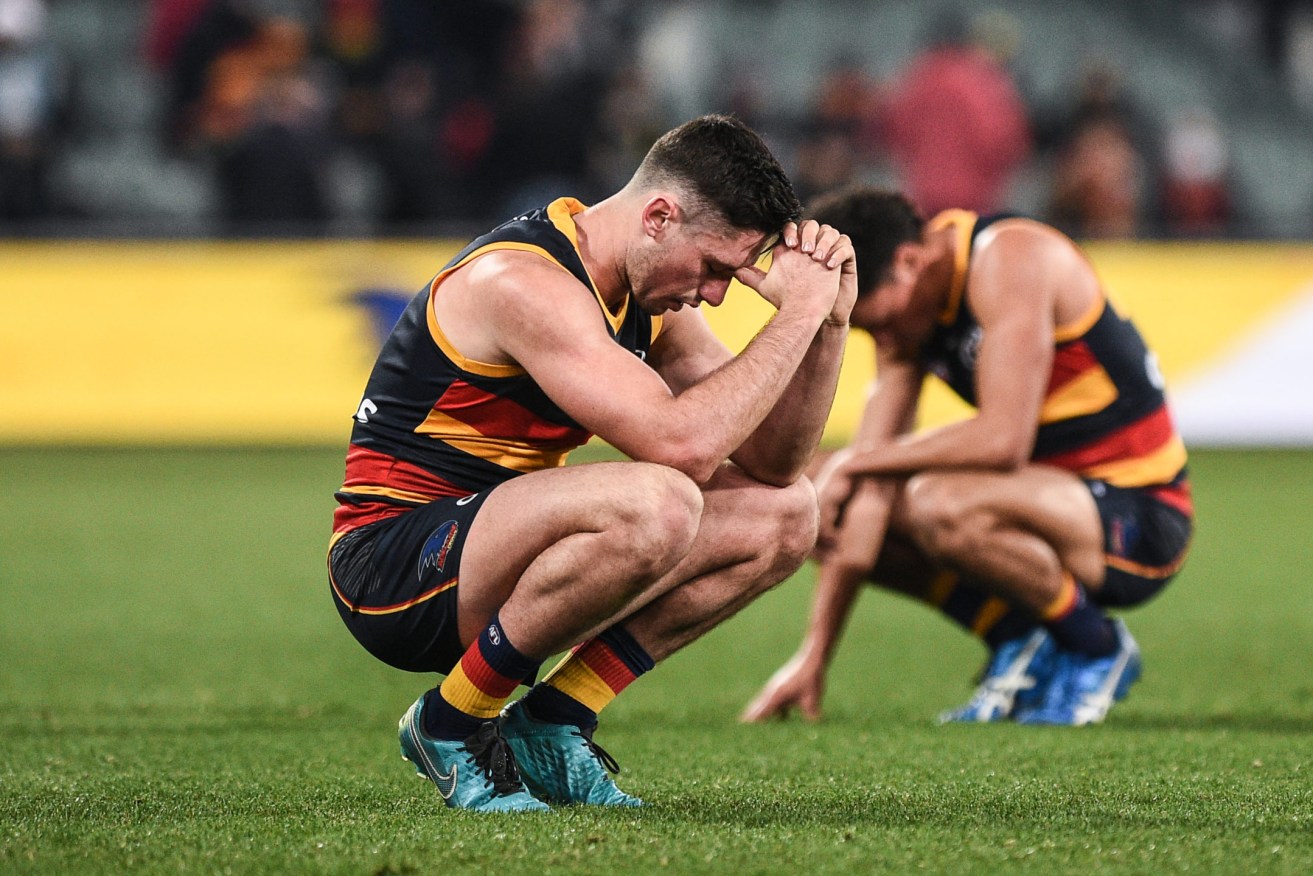 Crows players after the final siren on Saturday. Photo: Michael Errey / InDaily