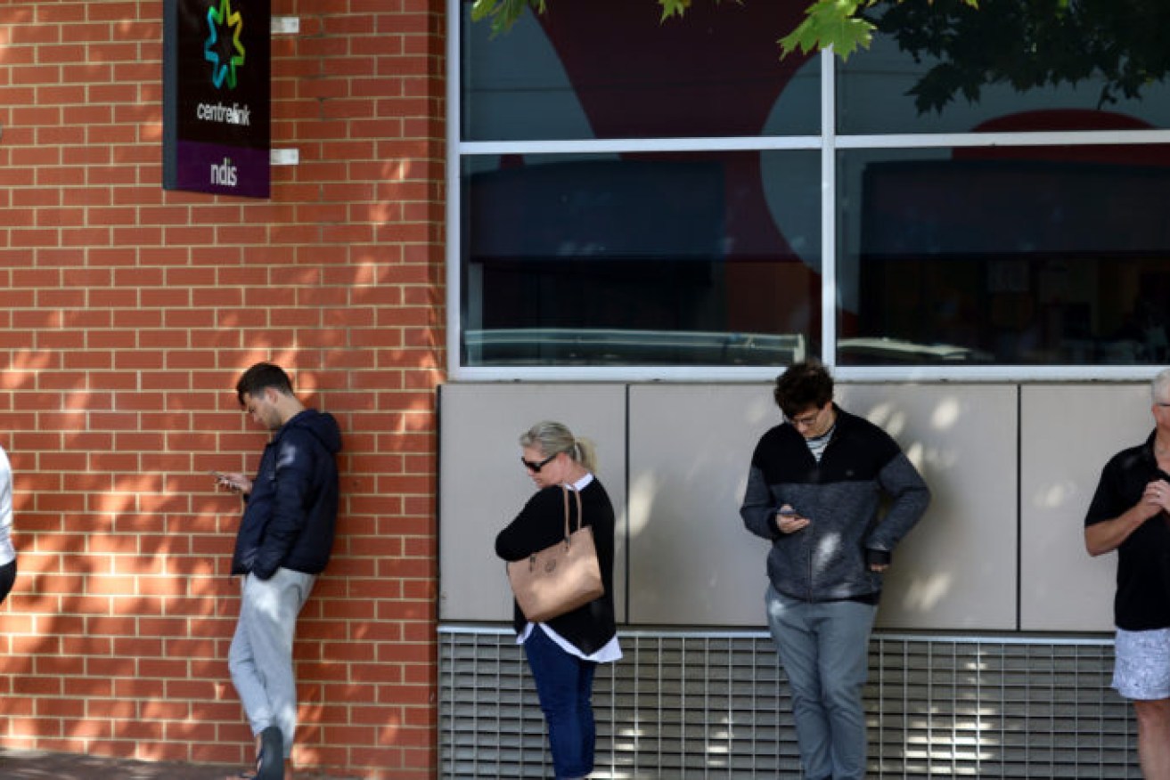 July's unemployment figures are a huge improvement on April 2020 when people queued outside the Norwood Centrelink office after losing their jobs. Picture: Kelly Barnes/AAP. 