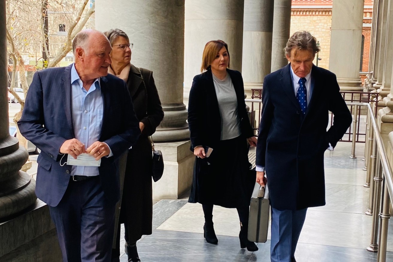 John Hanlon arrives at parliament today with his wife, along with former colleague Georgina Vasilevski and her lawyer.