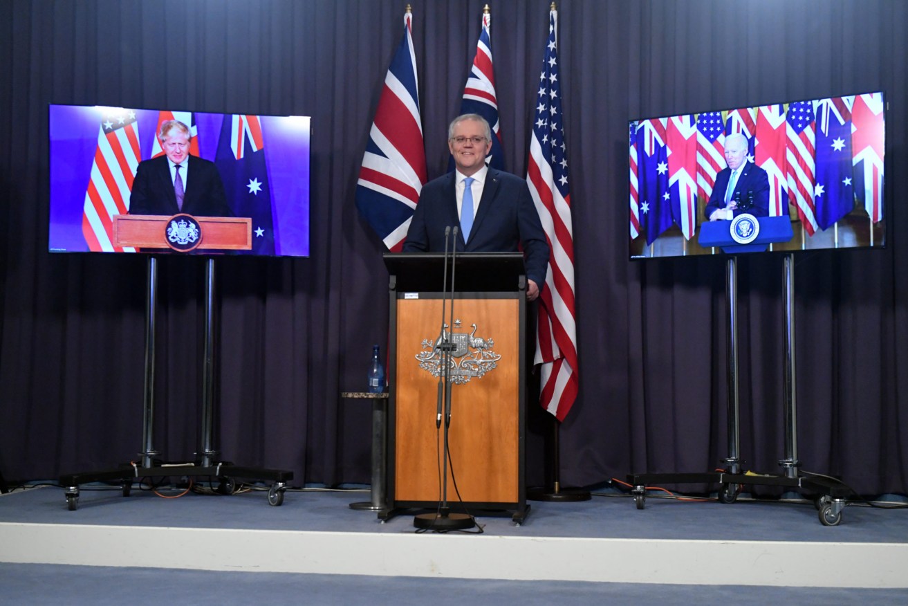 Scott Morrison flanked by live feeds of Britain’s Boris Johnson and US President Joe Biden at Thursday's joint press conference to announce a new alliance and SA nuclear subs build. Photo: Mick Tsikas / AAP