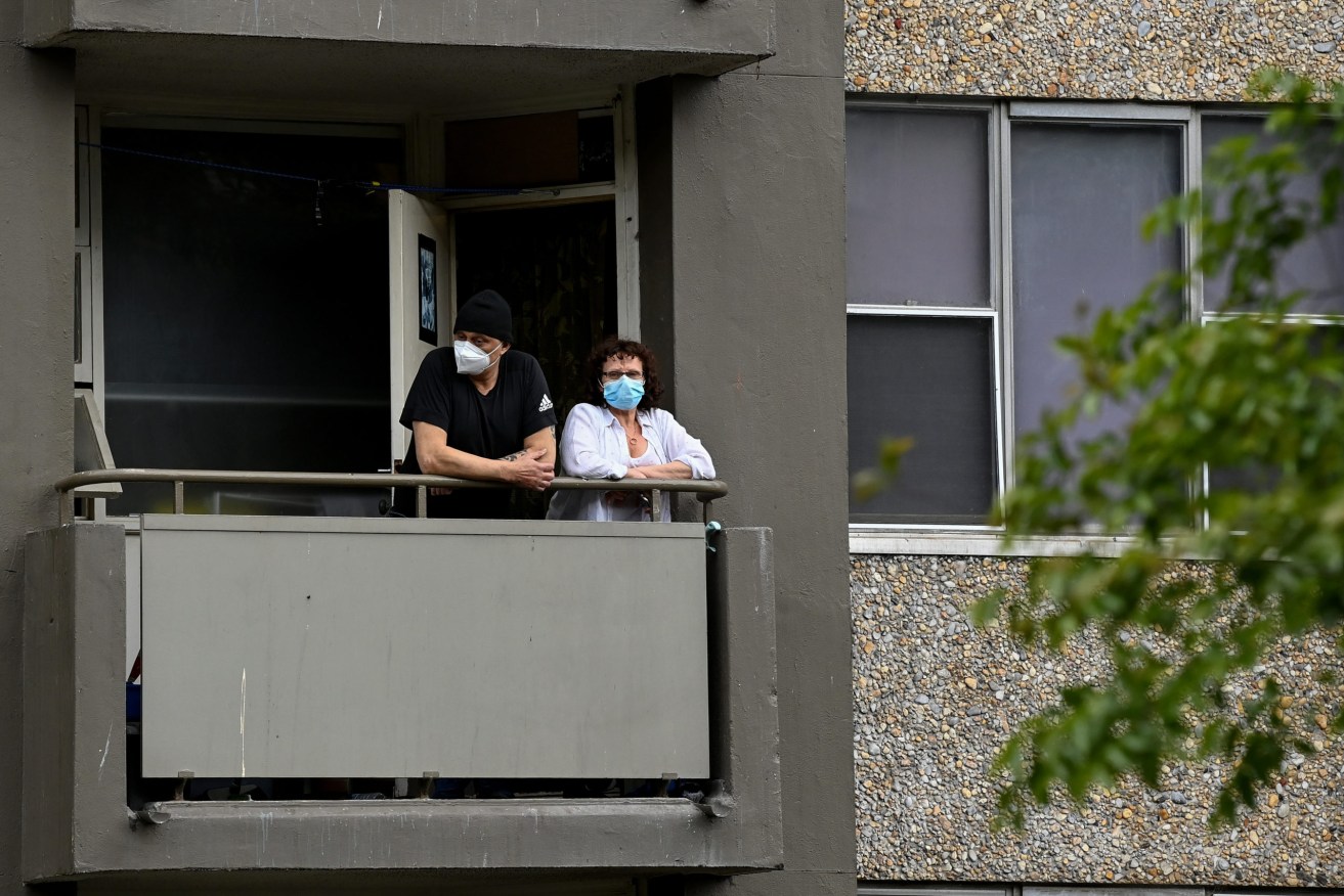Residents stand on their balcony at the Kendall social housing tower in the suburb of Redfern, Sydney, Thursday, September 16, 2021. (AAP Image/Bianca De Marchi)