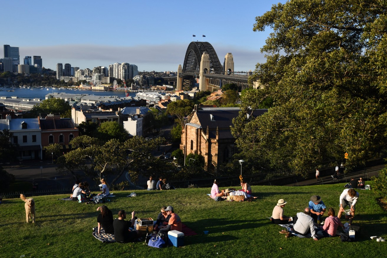 Locals gather at Observatory Hill after picnic restrictions were lifted in Sydney, Sunday, September 19, 2021. (AAP Image/Joel Carrett)